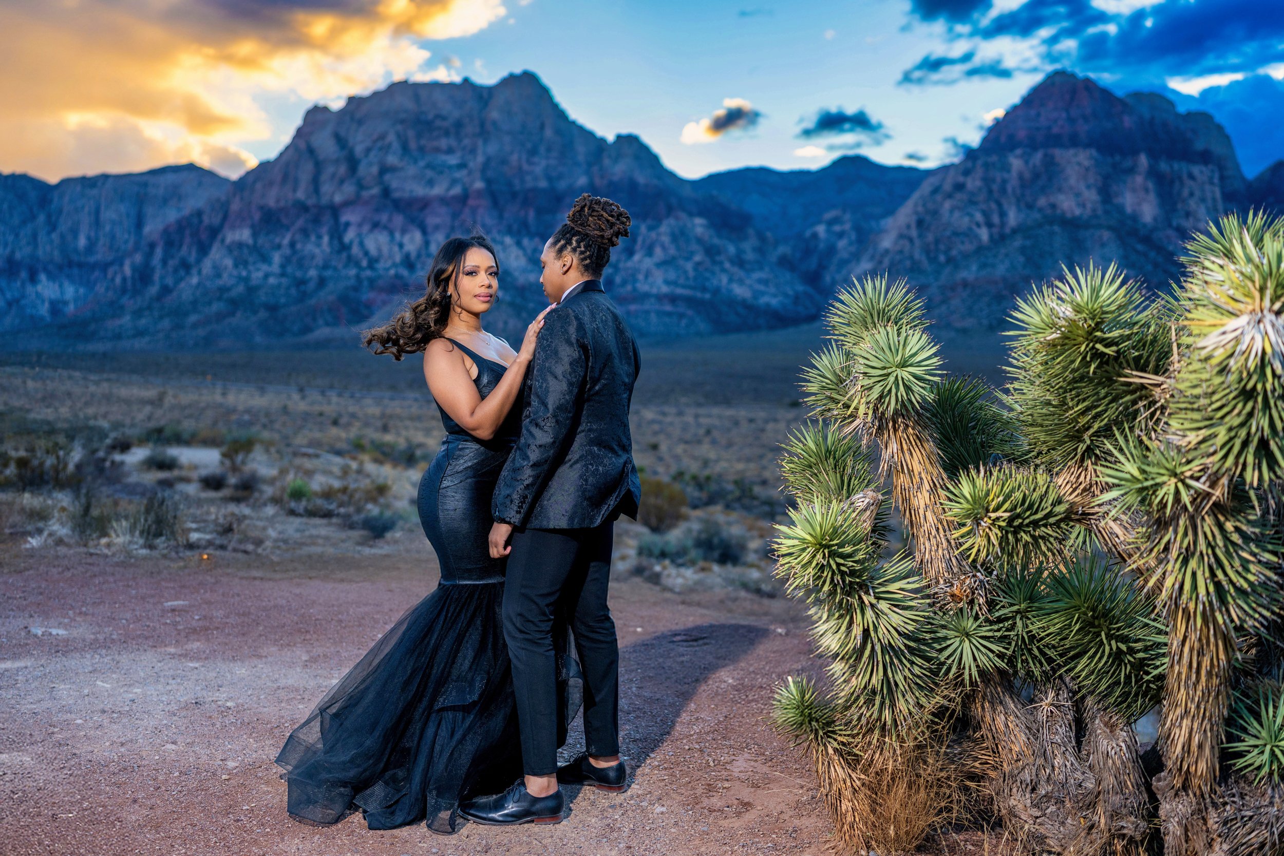 Las Vegas engagement photography — couple embracing with Red Rock mountains behind